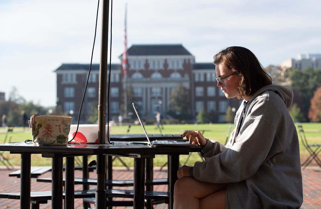 student studying on the drill field