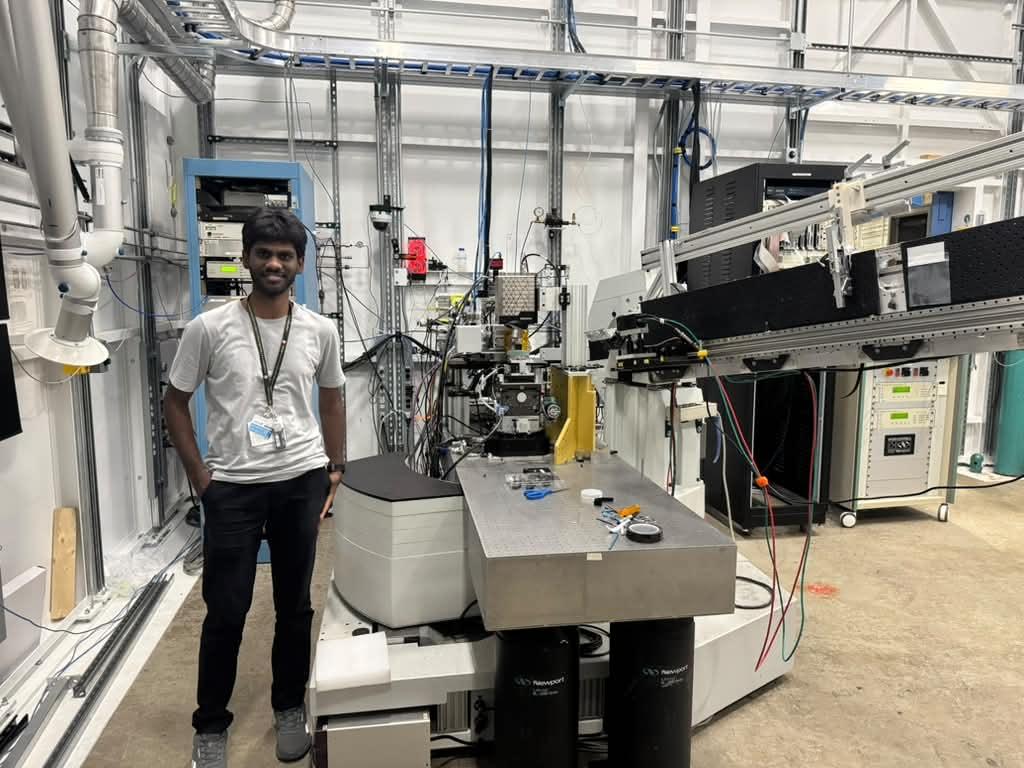 Palani Karthikeyan at Argonne standing next to lab equipment