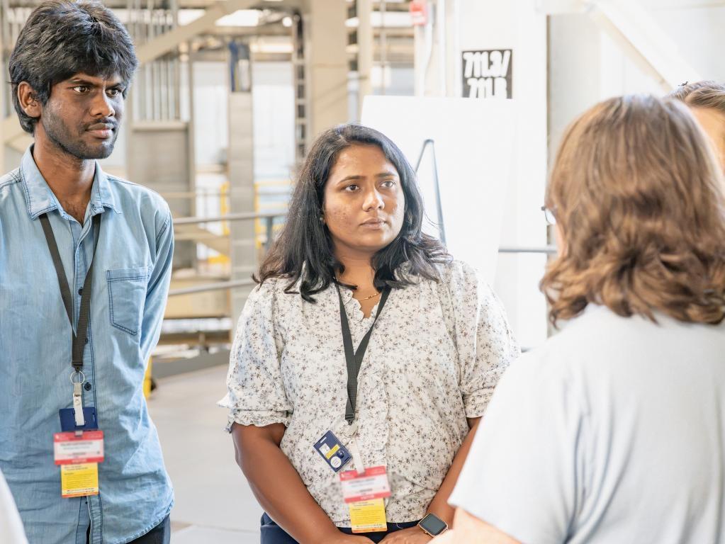 Palani Karthikeyan and a female student listening to an instructor speak